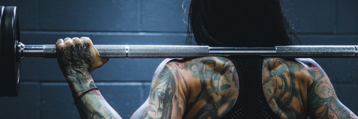 woman carrying barbell